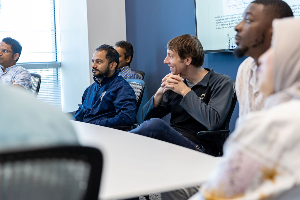 BiomEdit team members collaborating in a lab meeting