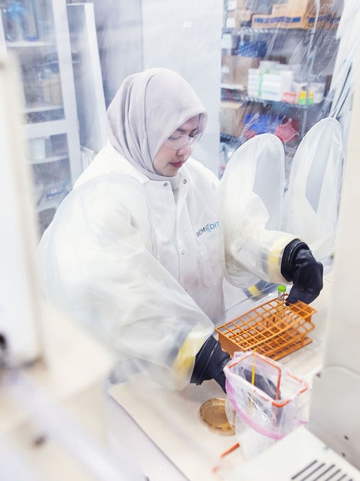 BiomEdit scientist working in a biosafety cabinet